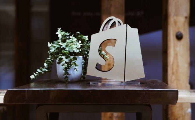 Shopify Logo als aufsteller auf einem Tisch